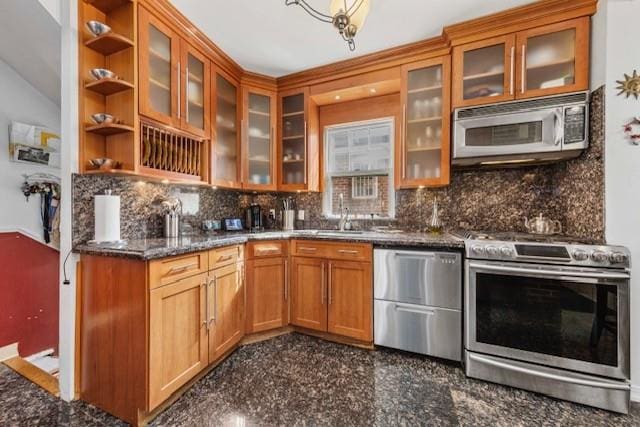 kitchen with stainless steel appliances, brown cabinets, granite finish floor, and tasteful backsplash