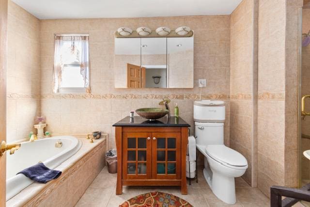 bathroom with toilet, tile walls, a bath, and tile patterned floors