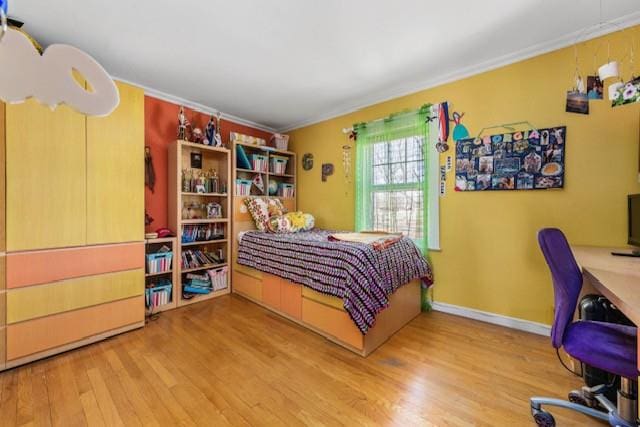 bedroom featuring ornamental molding, baseboards, and wood finished floors