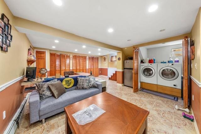 living room featuring a baseboard heating unit, wainscoting, washing machine and clothes dryer, and recessed lighting