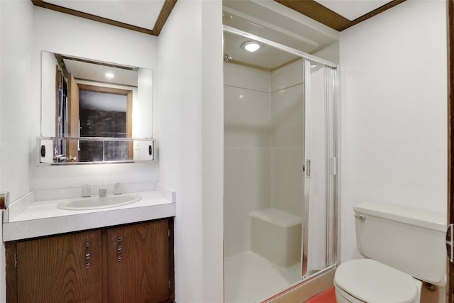 full bath with a stall shower, vanity, and toilet