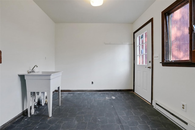 entryway featuring stone finish flooring, a baseboard radiator, and baseboards