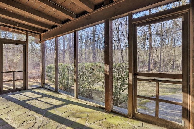 unfurnished sunroom with wood ceiling and beam ceiling