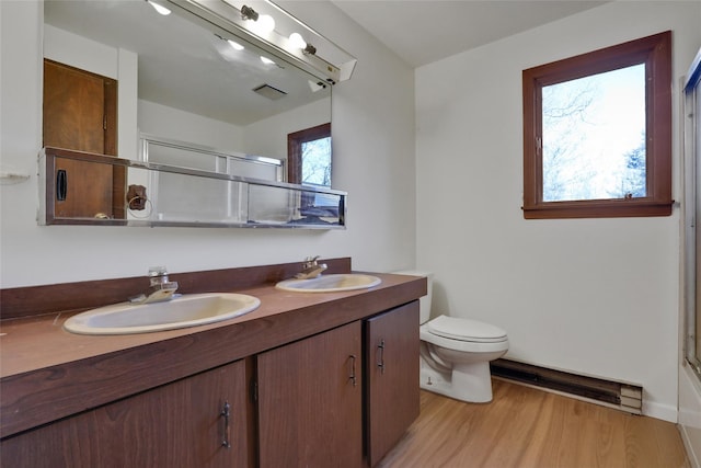 bathroom featuring toilet, an enclosed shower, a sink, and visible vents