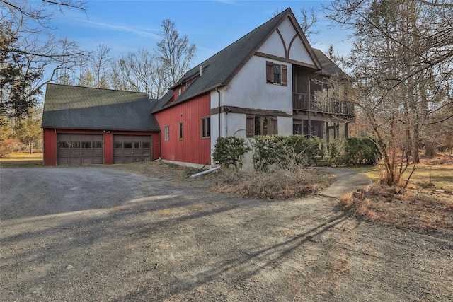 view of front facade featuring driveway, a balcony, and a garage