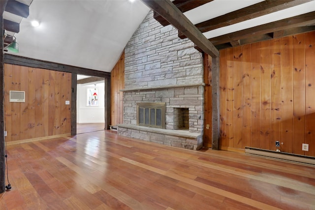 unfurnished living room featuring vaulted ceiling with beams, a stone fireplace, a baseboard radiator, and wood finished floors