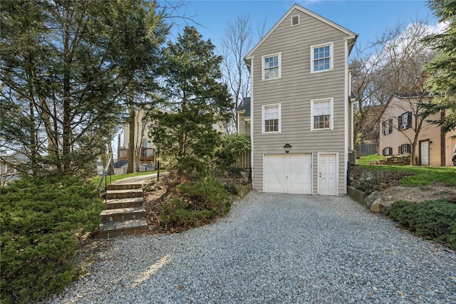 view of side of home with driveway and a garage