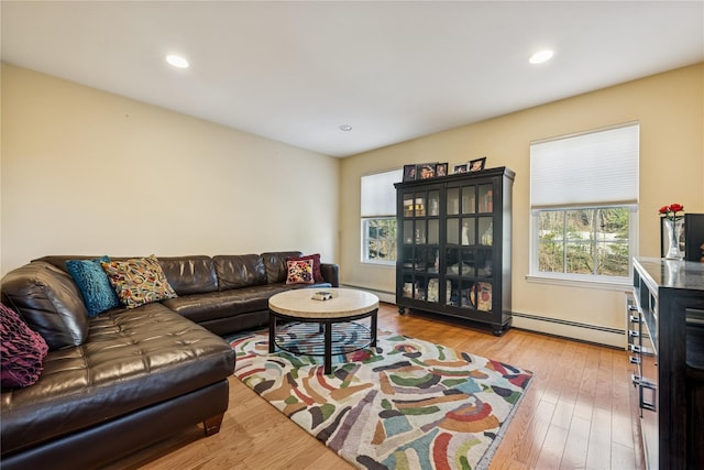 living area featuring recessed lighting, a baseboard heating unit, light wood-style floors, and a baseboard radiator