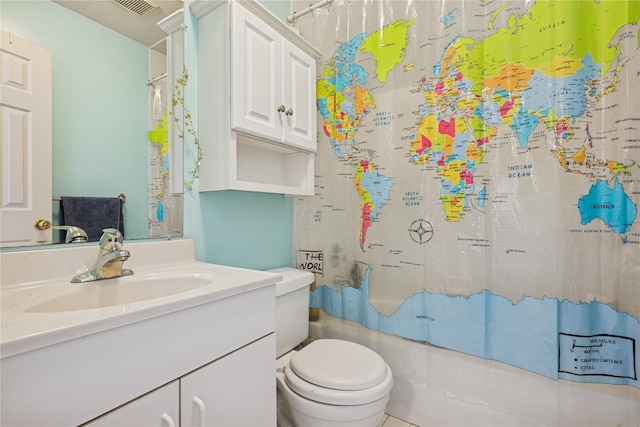 bathroom featuring toilet, vanity, and shower / tub combo