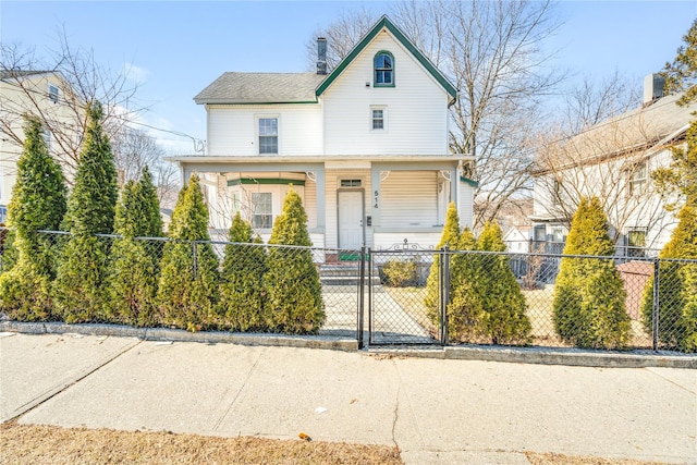 view of front of home with a fenced front yard and a chimney