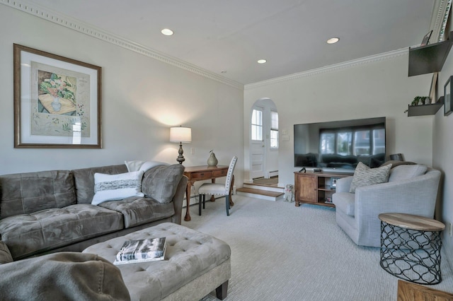 living area featuring arched walkways, recessed lighting, a baseboard heating unit, carpet flooring, and ornamental molding