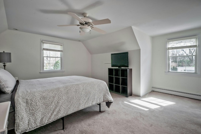 bedroom with lofted ceiling, a baseboard radiator, ceiling fan, and carpet flooring