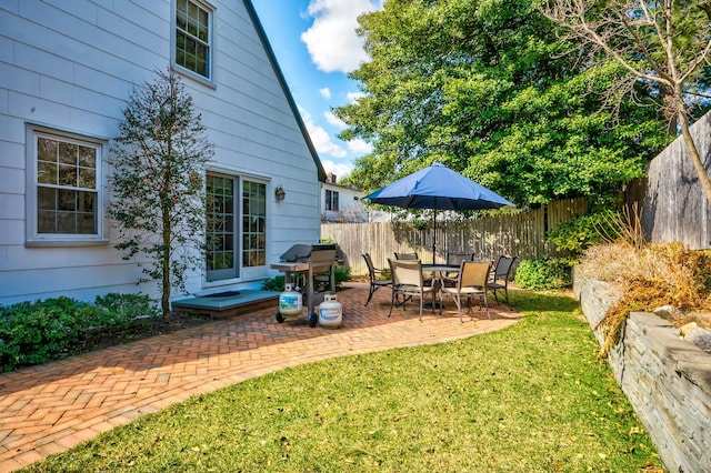 view of yard with a fenced backyard and a patio