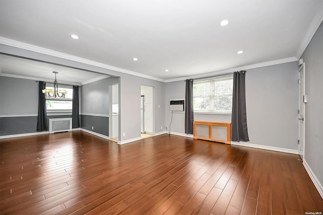 unfurnished living room with baseboards, a wall unit AC, radiator heating unit, wood finished floors, and a notable chandelier