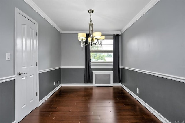 unfurnished dining area featuring a chandelier, ornamental molding, baseboards, and wood finished floors