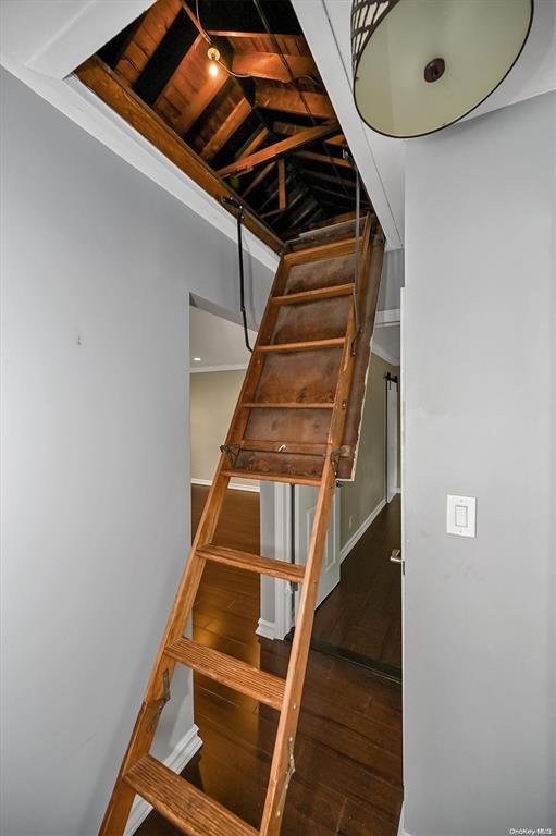 stairway with hardwood / wood-style flooring and baseboards