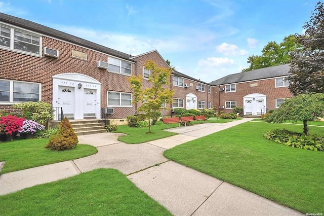 multi unit property with brick siding, crawl space, and a front yard