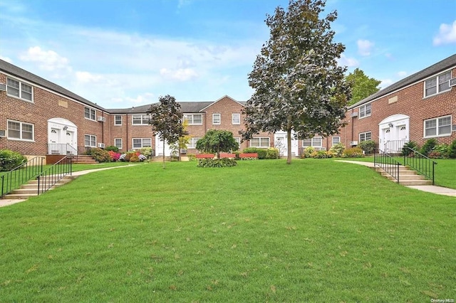 view of community with a residential view and a yard