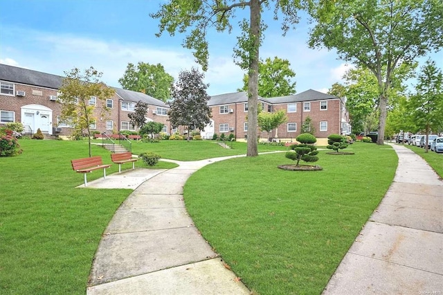 view of home's community featuring a residential view and a lawn