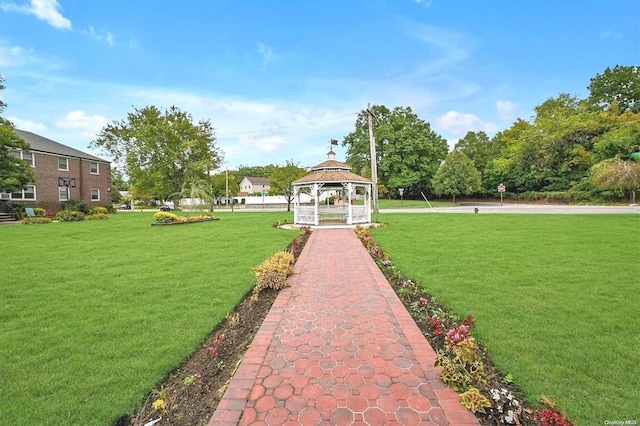 view of property's community with a lawn and a gazebo