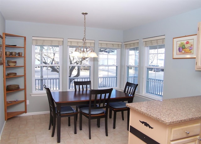 dining room featuring baseboards and an inviting chandelier