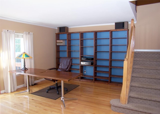 office space featuring crown molding, baseboards, and wood finished floors