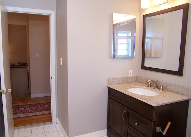 bathroom with tile patterned flooring, vanity, and baseboards