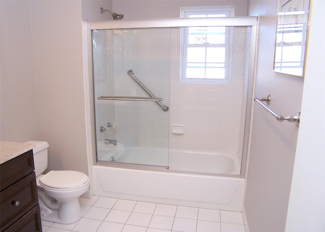 bathroom with shower / bath combination with glass door, vanity, toilet, and tile patterned floors