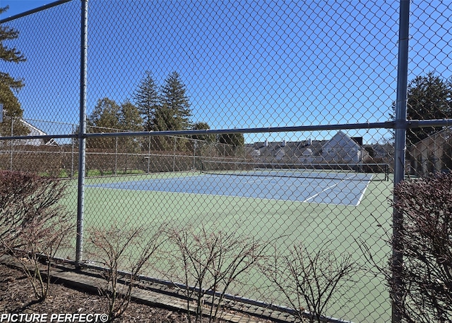 view of sport court featuring fence