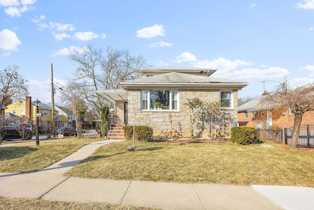 bungalow-style house featuring a front yard, stone siding, fence, and a residential view