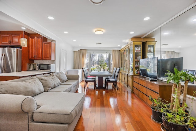 living area featuring light wood-style floors and recessed lighting