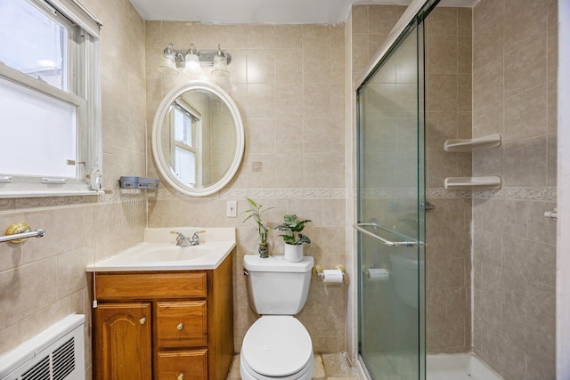 full bath featuring a stall shower and tile walls