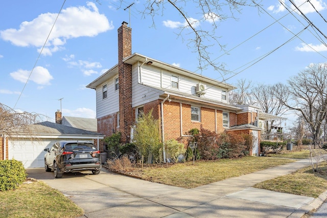 view of side of home with driveway, a garage, a chimney, a yard, and brick siding