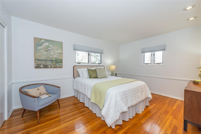 bedroom with baseboards, hardwood / wood-style flooring, and recessed lighting