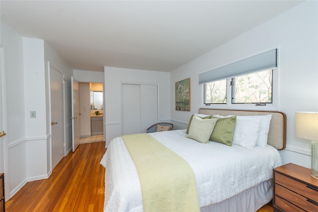 bedroom with a closet and wood finished floors