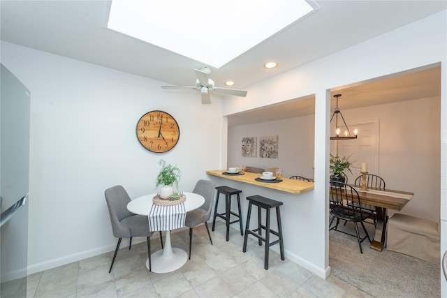 dining room featuring ceiling fan with notable chandelier, recessed lighting, and baseboards