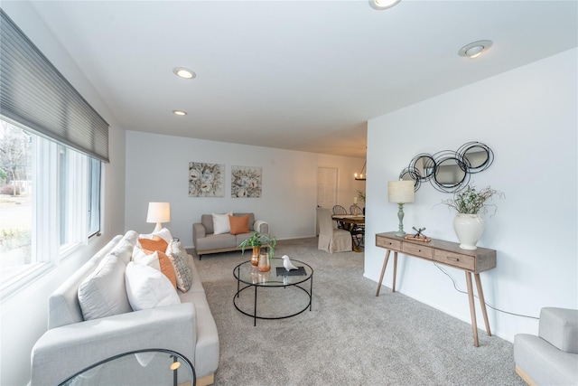 carpeted living area with recessed lighting and baseboards