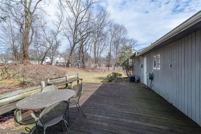 wooden terrace with outdoor dining area and central AC