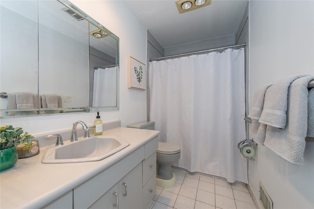 bathroom featuring visible vents, vanity, toilet, and tile patterned floors