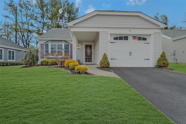 view of front of home featuring driveway, an attached garage, a front lawn, and a shingled roof