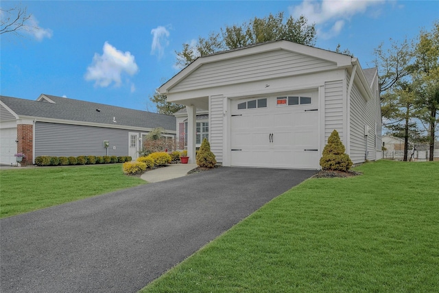 view of front of house featuring driveway, a garage, and a front lawn