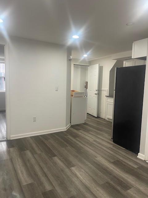 interior space featuring recessed lighting, baseboards, washer / dryer, and dark wood-style floors