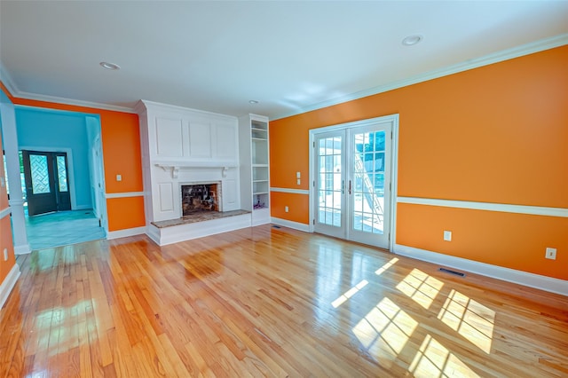 unfurnished living room with ornamental molding, french doors, visible vents, and plenty of natural light