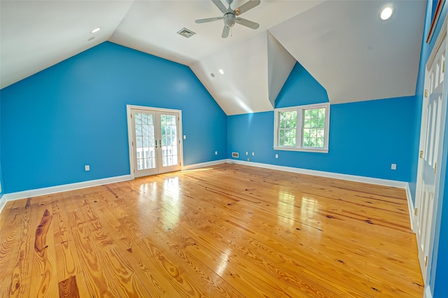 additional living space with baseboards, visible vents, hardwood / wood-style flooring, vaulted ceiling, and french doors