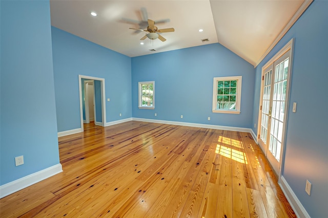 spare room featuring visible vents, baseboards, a ceiling fan, vaulted ceiling, and light wood-style floors