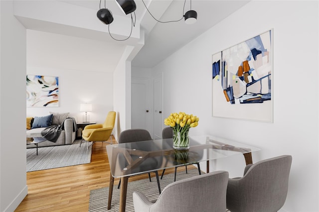 dining space featuring light wood-style floors and baseboards