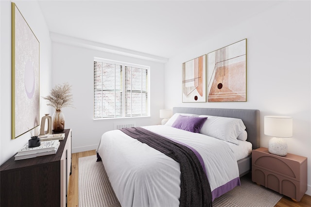 bedroom featuring baseboards, visible vents, and wood finished floors