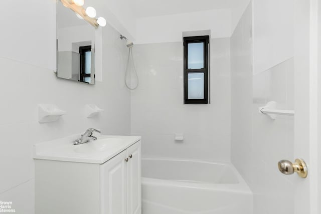 bathroom featuring  shower combination and vanity