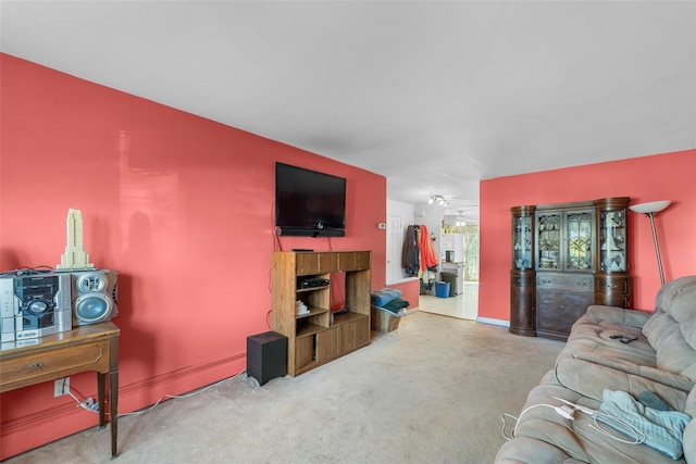 living room featuring carpet and baseboards