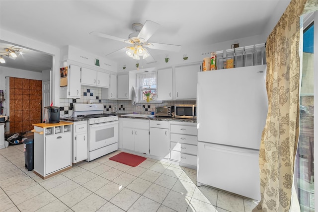 kitchen with backsplash, white cabinets, a sink, ceiling fan, and white appliances